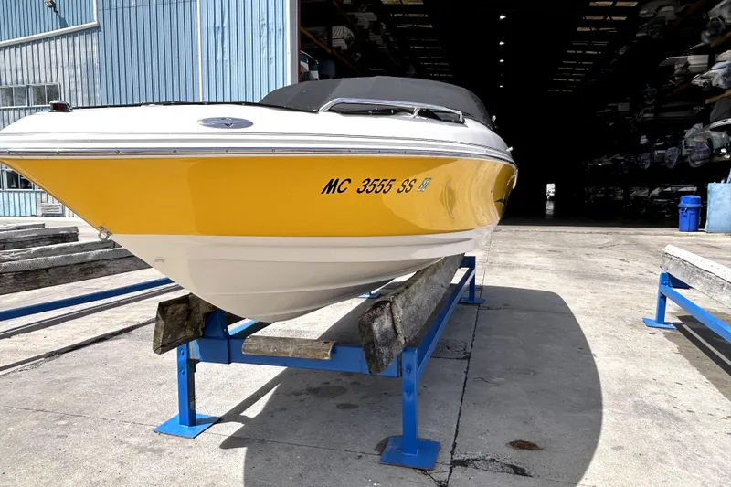 Slide: The Image of 2003 Monterey 218LS Montura Bowrider in storage, yellow hull, on blue supports. - 28