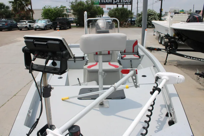Slide: The Image of 2018 G3 Bay 18 DLX boat with modern equipment and seating, parked outdoors. - 15