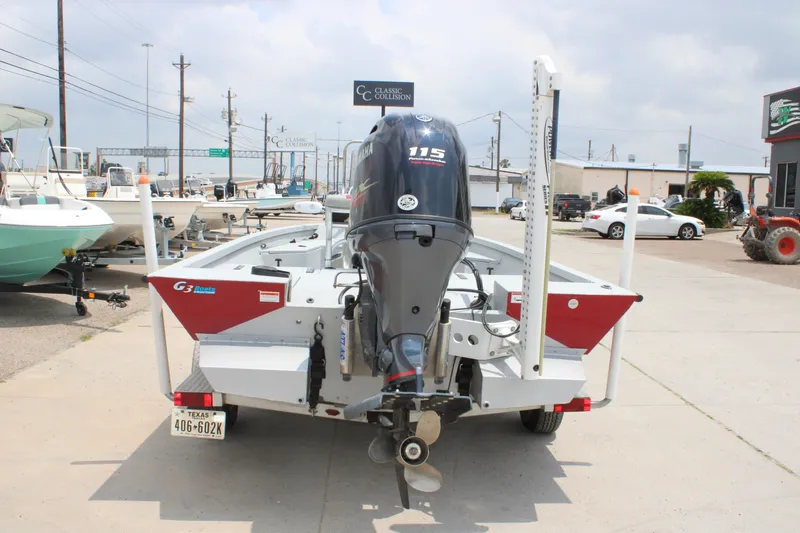 Slide: The Image of 2018 G3 Bay 18 DLX boat with Yamaha 115 engine, parked outdoors. - 6