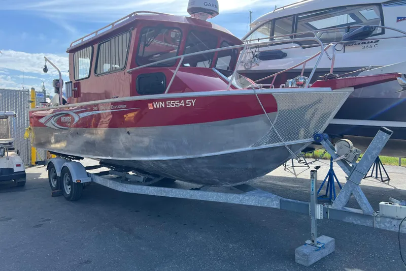 The Image of 2018 Hewescraft 240 Pacific Cruiser Hardtop on trailer, red and silver design. - 0