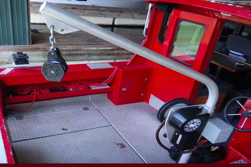 Slide: The Image of 2018 Hewescraft 240 Pacific Cruiser Hardtop interior with red accents and winch system. - 5