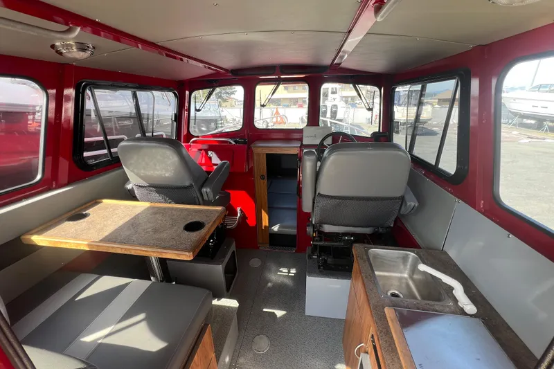 Slide: The Image of Interior of 2018 Hewescraft 240 Pacific Cruiser Hardtop with seating, table, and sink. - 7