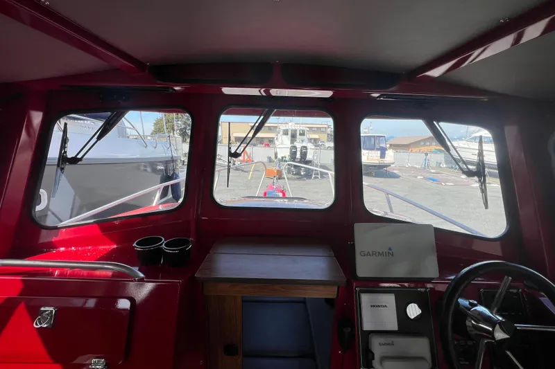 Slide: The Image of Interior view of 2018 Hewescraft 240 Pacific Cruiser Hardtop boat with Garmin navigation system. - 9