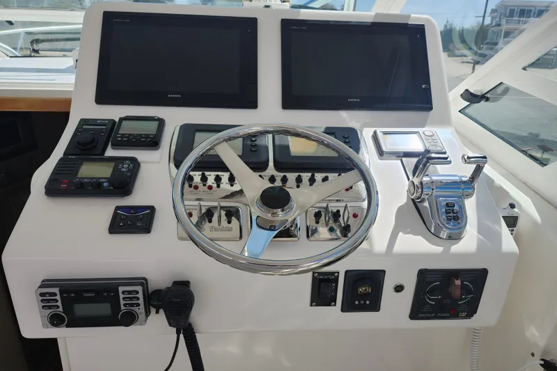 Slide: The Image of Helm of 2009 Cabo 36 Express boat with navigation and control systems. - 11