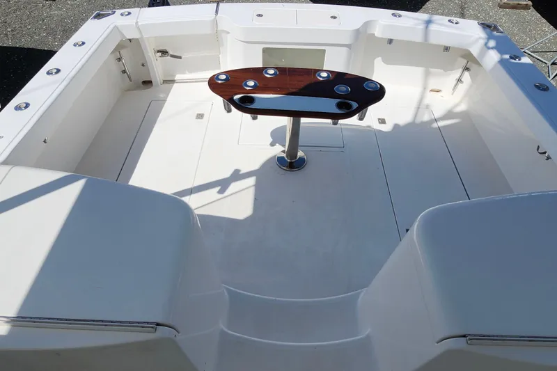 Slide: The Image of 2009 Cabo 36 Express boat cockpit with sleek design and central table. - 13