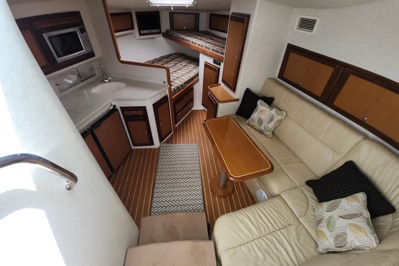 Slide: The Image of Interior of 2009 Cabo 36 Express yacht with kitchen, seating, and sleeping area. - 14