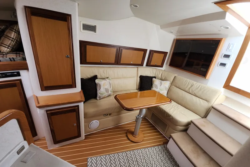 Slide: The Image of Luxurious interior of 2009 Cabo 36 Express yacht with beige seating and wooden accents. - 15