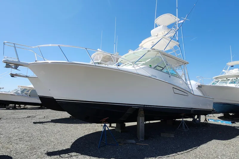 Slide: The Image of 2009 Cabo 36 Express boat on dry dock under clear blue sky. - 5