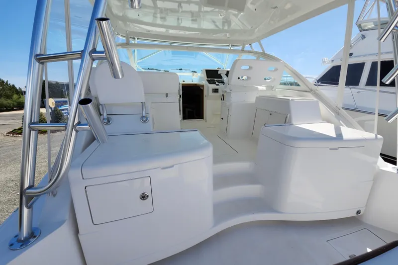 Slide: The Image of 2009 Cabo 36 Express boat interior with seating and helm, showcasing sleek design. - 7