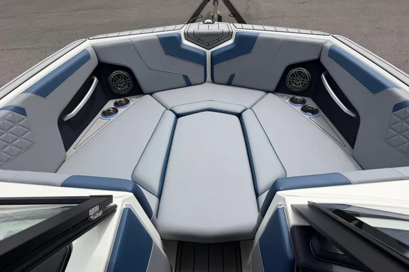 Slide: The Image of 2026 Nautique Super Air Nautique GS24 boat interior with luxurious seating and cup holders. - 10