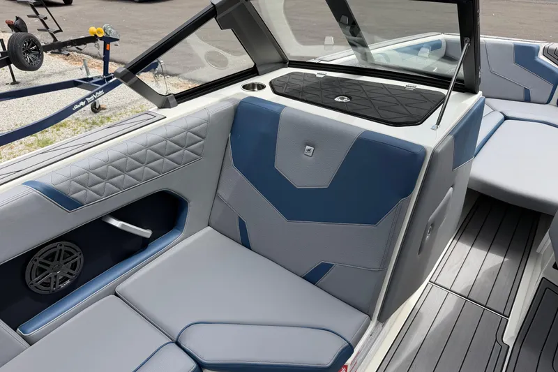 Slide: The Image of 2026 Nautique Super Air Nautique GS24 interior with blue and gray seating, modern design. - 13