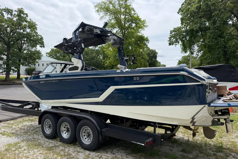 Slide: The Image of 2026 Nautique Super Air Nautique GS24 boat on trailer, parked outdoors. - 3
