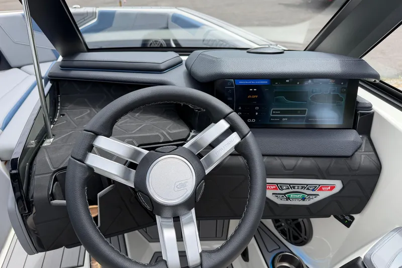 Slide: The Image of 2026 Nautique Super Air Nautique GS24 dashboard with modern steering wheel and digital display. - 9