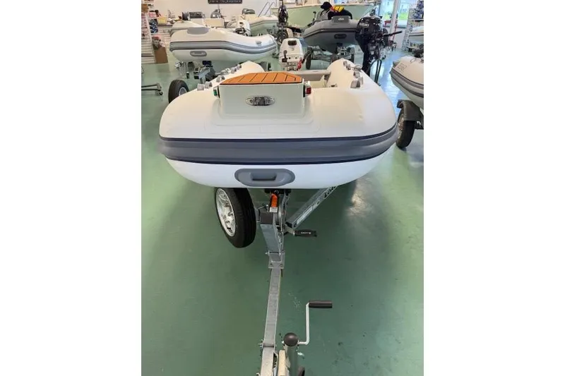 Slide: The Image of 2026 Desner Classic CL 340 inflatable boat on trailer in showroom. - 5