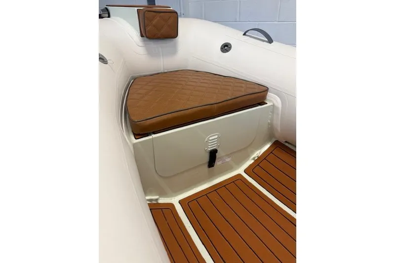 Slide: The Image of Interior of 2026 Desner Classic CL 340 boat with brown cushioned seating. - 6