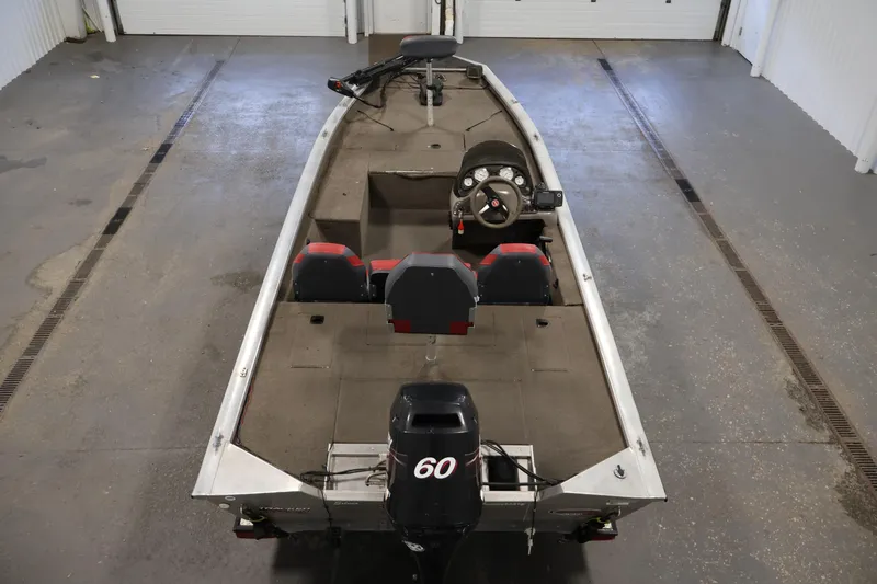 Slide: The Image of 2003 Tracker Pro Team 175 boat in a garage, featuring a 60 HP motor. - 10
