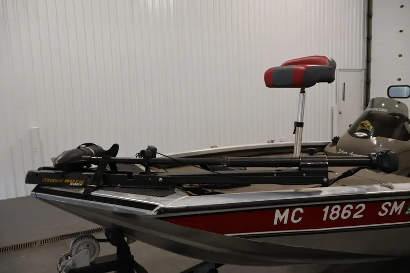Slide: The Image of 2003 Tracker Pro Team 175 boat with Minn Kota trolling motor in a garage. - 11