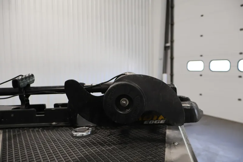 Slide: The Image of Trolling motor on 2003 Tracker Pro Team 175 boat in a garage setting. - 13