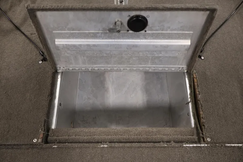 Slide: The Image of Open storage compartment in 2003 Tracker Pro Team 175 boat, showing interior details. - 17
