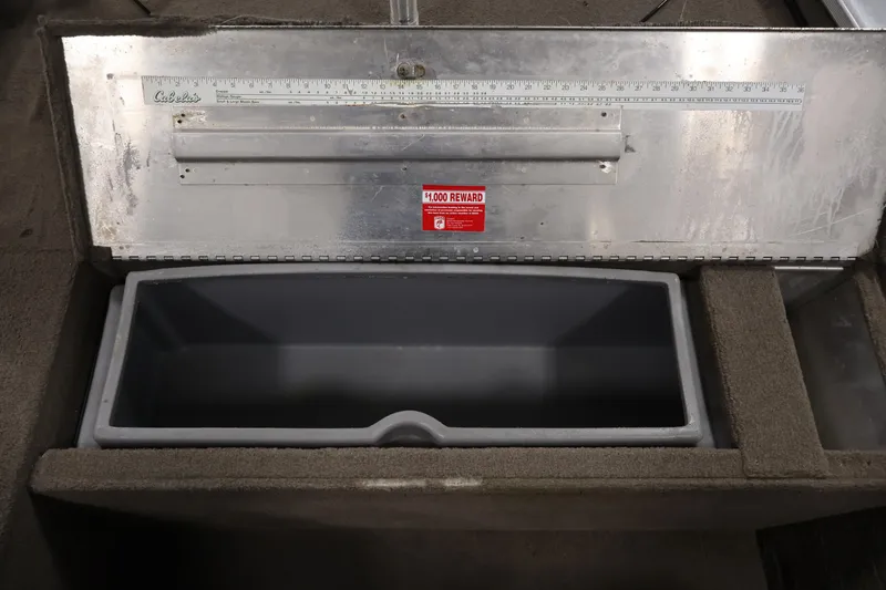 Slide: The Image of 2003 Tracker Pro Team 175 boat storage compartment with measuring ruler and reward sticker. - 18
