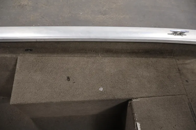 Slide: The Image of Interior view of a 2003 Tracker Pro Team 175 boat, featuring carpeted flooring. - 19