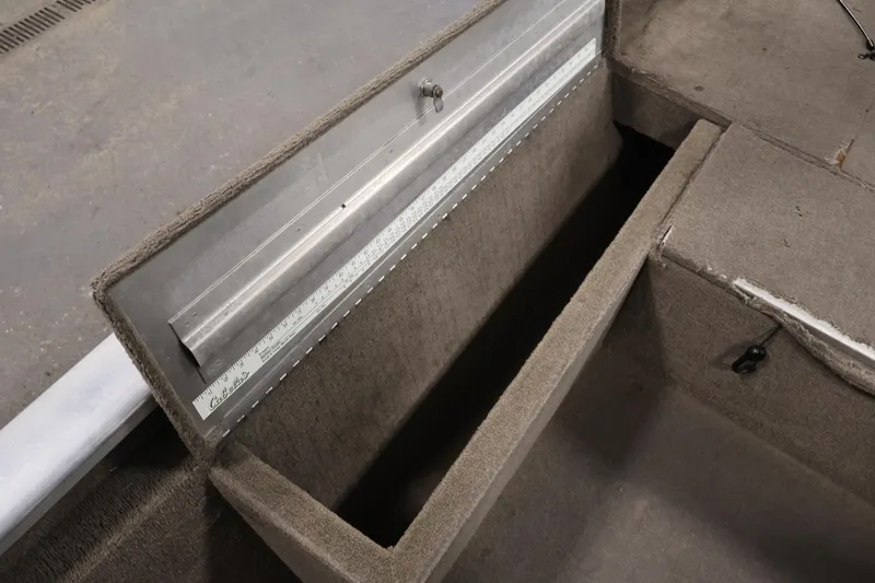 Slide: The Image of 2003 Tracker Pro Team 175 boat storage compartment with measuring ruler. - 20