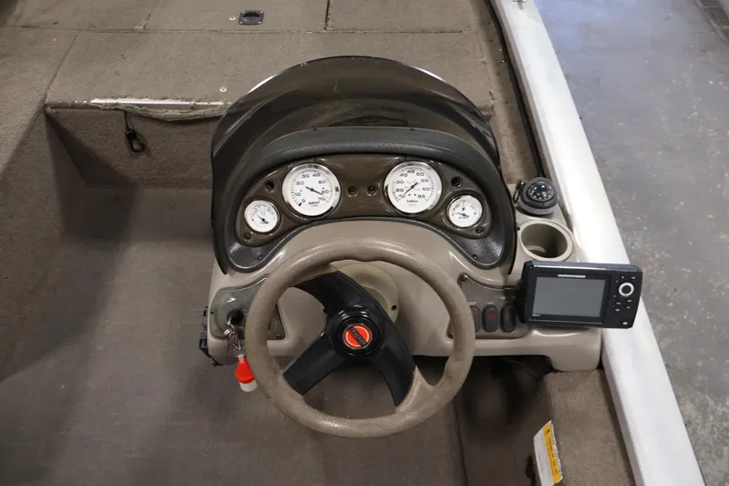 Slide: The Image of 2003 Tracker Pro Team 175 boat dashboard with steering wheel and gauges. - 22
