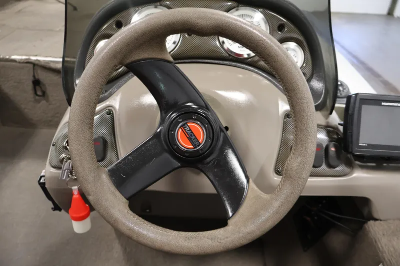Slide: The Image of Steering wheel of a 2003 Tracker Pro Team 175 boat with dashboard instruments. - 23
