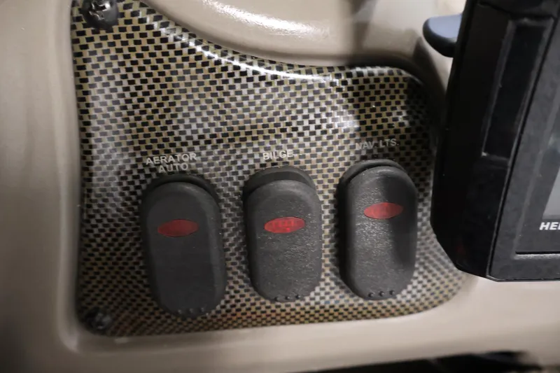 Slide: The Image of Control panel of a 2003 Tracker Pro Team 175 boat with switches for aerator, bilge, and navigation lights. - 27