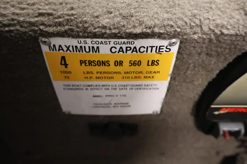 Slide: The Image of 2003 Tracker Pro Team 175 capacity label, 4 persons or 560 lbs, U.S. Coast Guard compliant. - 28