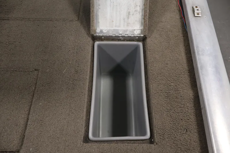 Slide: The Image of 2003 Tracker Pro Team 175 boat storage compartment with open lid, carpeted interior. - 35
