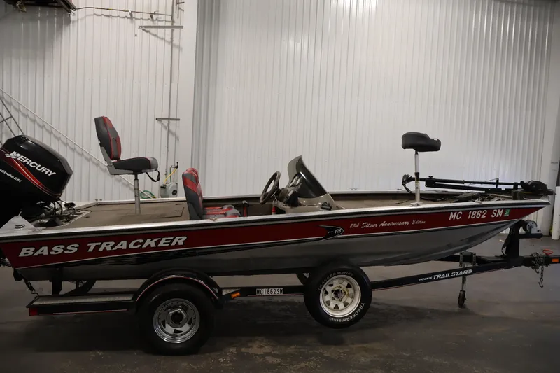 Slide: The Image of 2003 Tracker Pro Team 175 bass boat on trailer in indoor setting. - 4