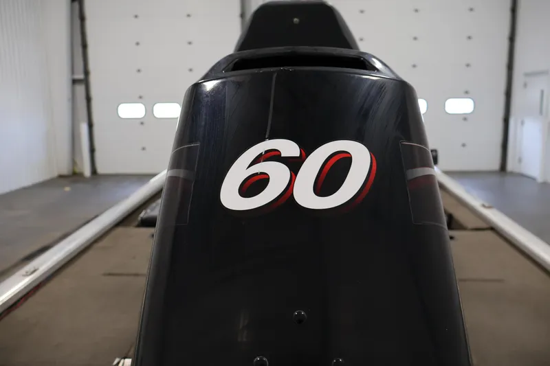 Slide: The Image of 2003 Tracker Pro Team 175 boat engine with '60' decal in a garage setting. - 41
