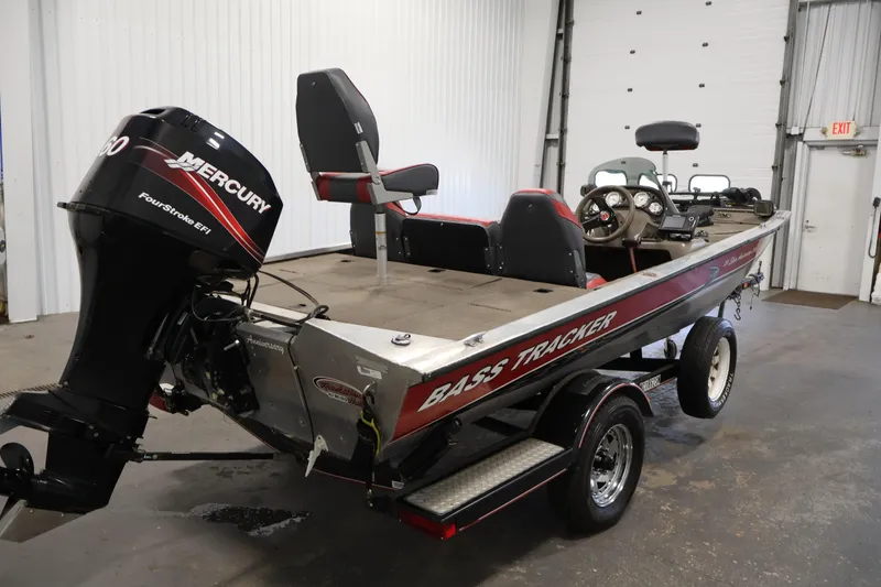 Slide: The Image of 2003 Tracker Pro Team 175 bass boat with Mercury FourStroke EFI engine in a garage. - 5