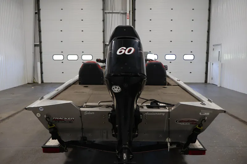 Slide: The Image of 2003 Tracker Pro Team 175 boat in a garage, rear view with motor. - 6