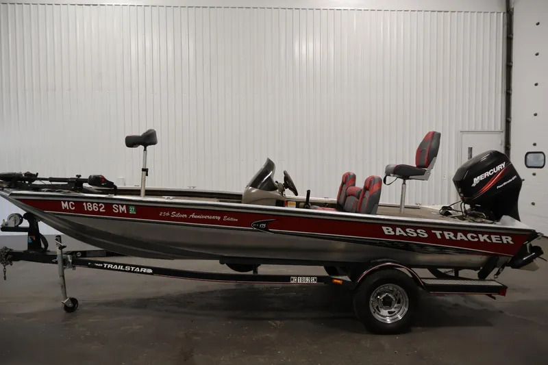 Slide: The Image of 2003 Tracker Pro Team 175 bass boat on trailer, featuring Mercury outboard motor. - 8