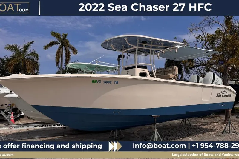 The Image of 2022 Sea Chaser 27 HFC CC boat displayed outdoors with palm trees in the background. - 1