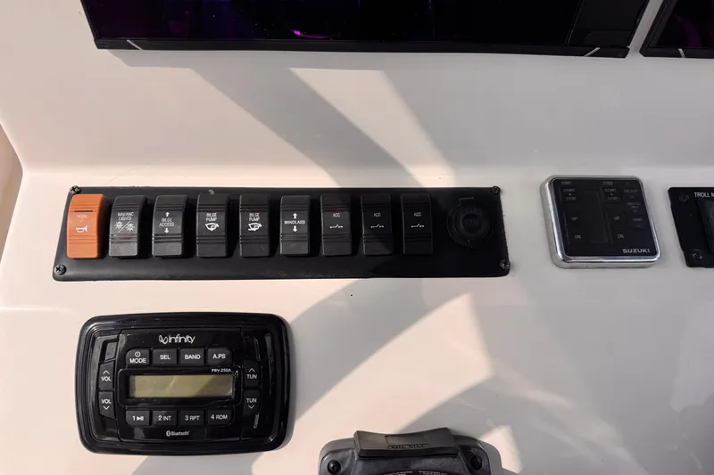 Slide: The Image of Control panel of 2022 Sea Chaser 27 HFC CC boat with switches and radio. - 14