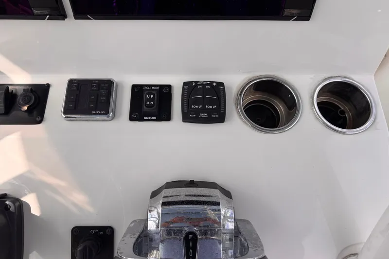 Slide: The Image of Control panel of 2022 Sea Chaser 27 HFC CC boat with switches and cup holders. - 15