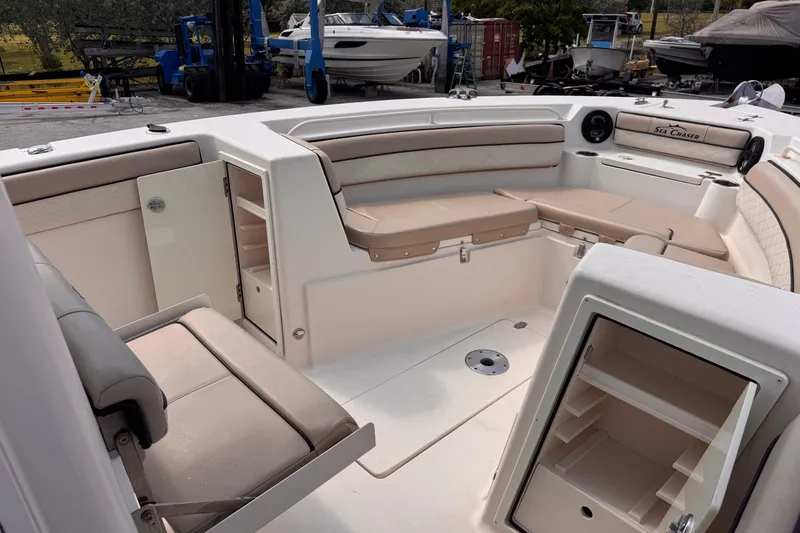Slide: The Image of 2022 Sea Chaser 27 HFC CC boat interior with seating and storage compartments. - 19