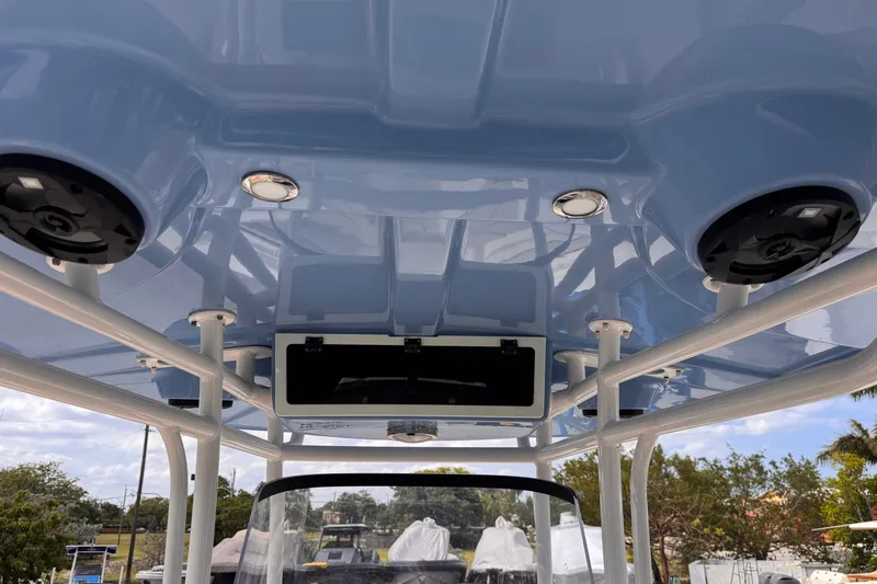 Slide: The Image of 2022 Sea Chaser 27 HFC CC boat's blue T-top with speakers and lights. - 22