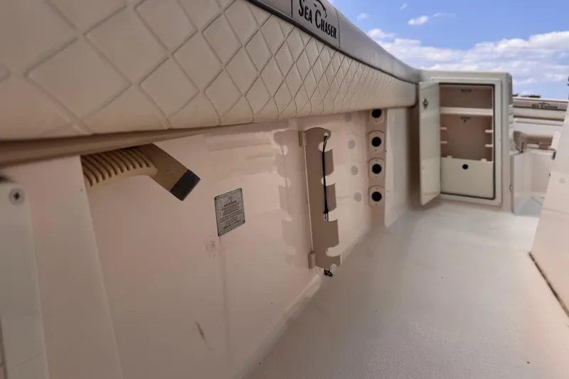 Slide: The Image of 2022 Sea Chaser 27 HFC CC boat interior with storage compartments and padded seating. - 24