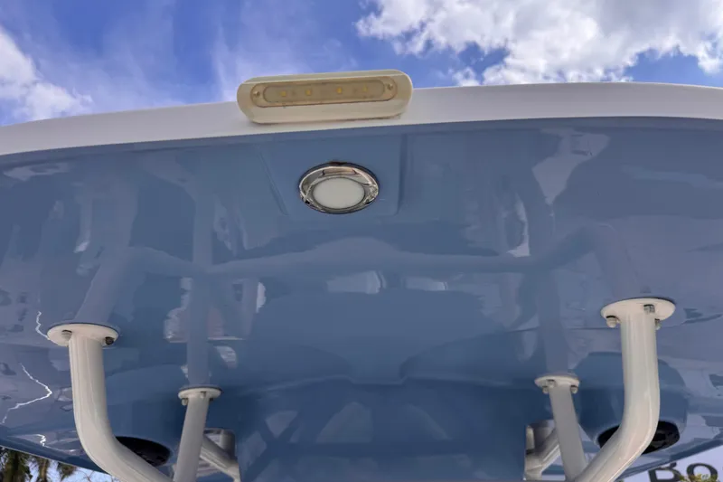 Slide: The Image of T-top view of 2022 Sea Chaser 27 HFC CC against a blue sky. - 25