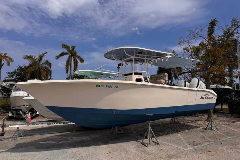 Slide: The Image of 2022 Sea Chaser 27 HFC CC boat on display, featuring a sleek design and dual engines. - 3
