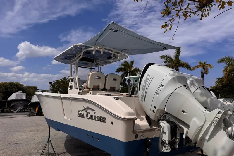 Slide: The Image of 2022 Sea Chaser 27 HFC CC boat with Suzuki outboard motor, parked under blue sky. - 5