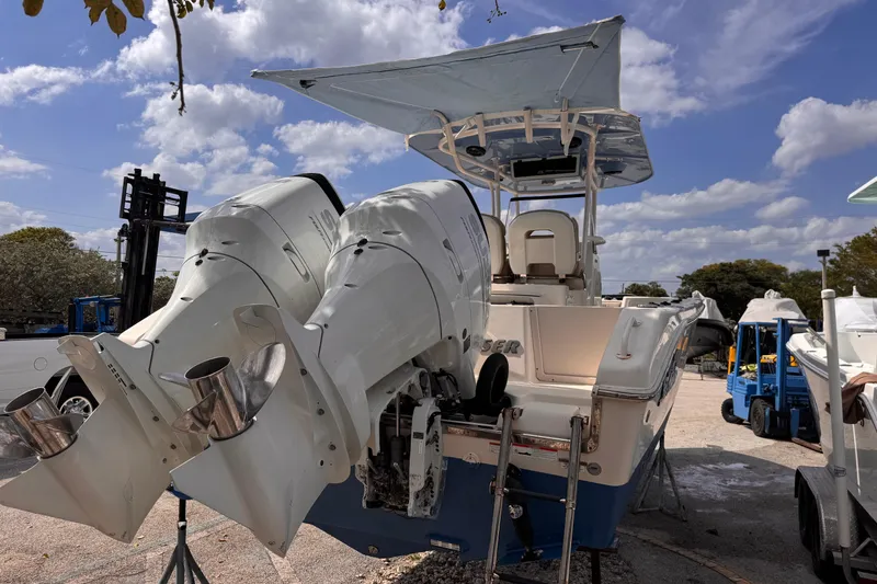 Slide: The Image of 2022 Sea Chaser 27 HFC CC boat with dual outboard engines, parked outdoors. - 6