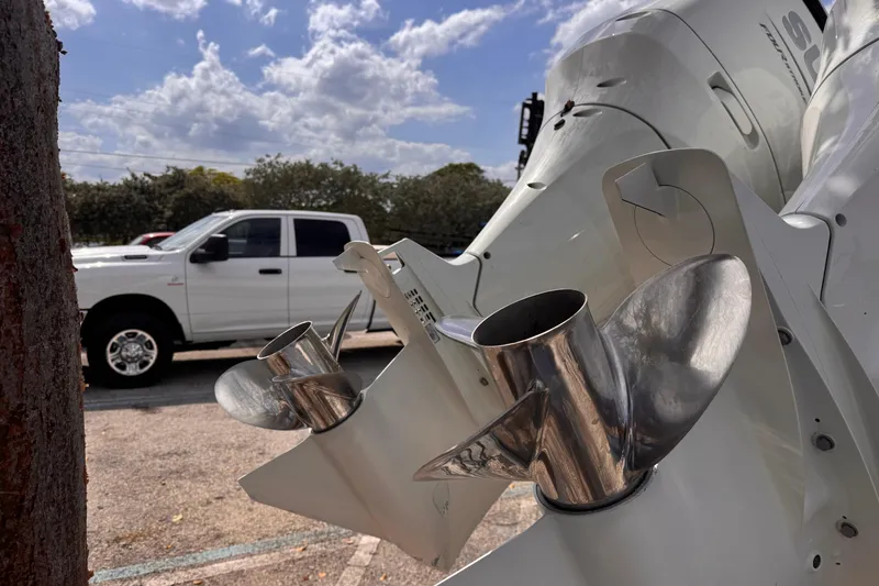 Slide: The Image of Close-up of 2022 Sea Chaser 27 HFC CC boat propellers with a white truck in the background. - 7
