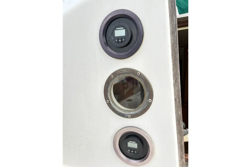 Slide: The Image of Control panel on a 1986 Cape Dory 26 sailboat with gauges and porthole. - 10