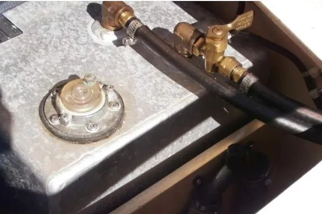 Slide: The Image of Fuel system components of a 1986 Cape Dory 26 boat, featuring valves and hoses. - 15