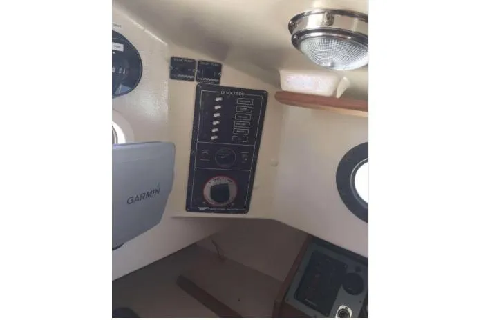 Slide: The Image of Interior view of 1986 Cape Dory 26 sailboat with control panel and Garmin device. - 7